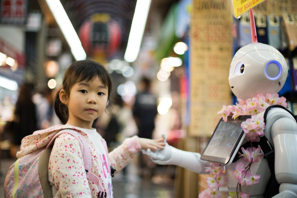 Child holding hands with robot